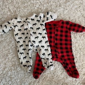 Set of warm onesies plaid and moose print. Only wore a few times.